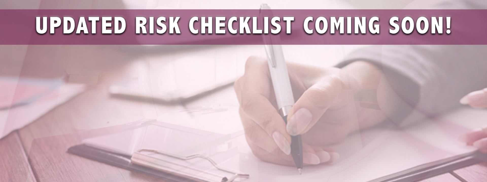 person filling out a form with the words updated risk checklist coming soon